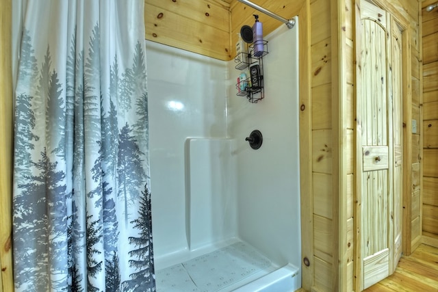 bathroom featuring a shower and hardwood / wood-style flooring