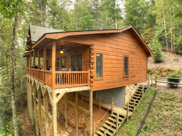 view of home's exterior with ceiling fan and a deck