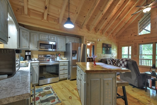 kitchen with gray cabinets, a kitchen island, and stainless steel appliances