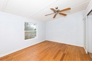 spare room with a ceiling fan and wood finished floors