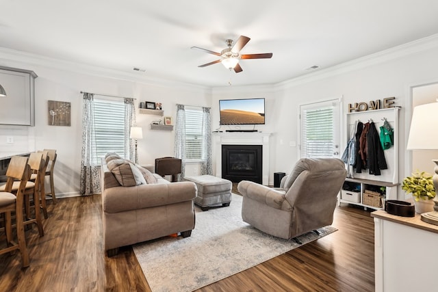 living room with ornamental molding and dark wood-type flooring