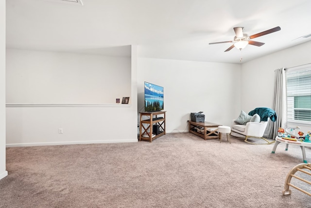 sitting room with visible vents, carpet flooring, baseboards, and ceiling fan