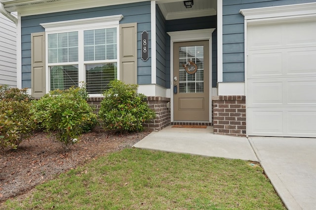 property entrance with an attached garage, a porch, and brick siding