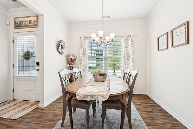 dining space featuring dark wood-type flooring, ornamental molding, a wealth of natural light, and an inviting chandelier