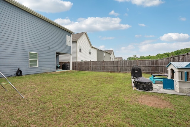 view of yard featuring a patio, a fire pit, and a fenced backyard