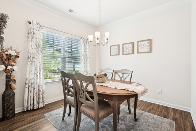 dining area with visible vents, wood finished floors, baseboards, a chandelier, and ornamental molding