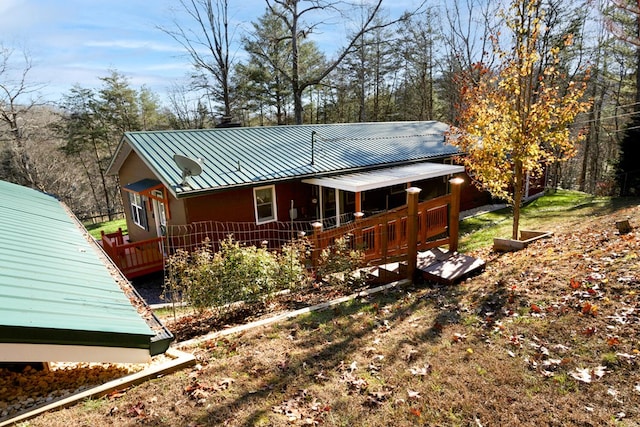 rear view of house with a wooden deck