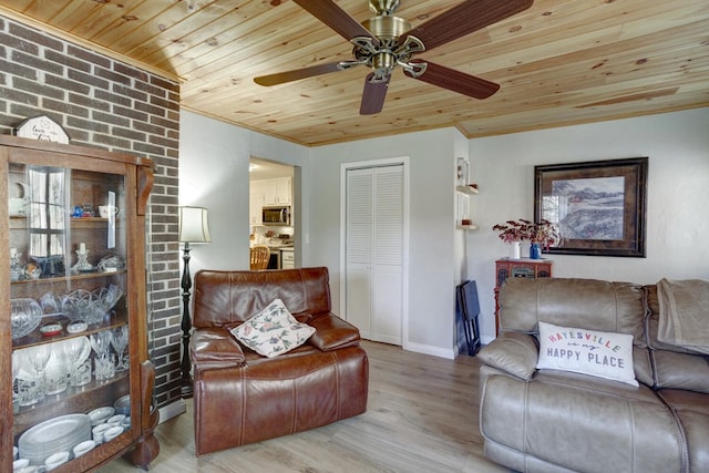 living room featuring wood ceiling, wood-type flooring, and ornamental molding