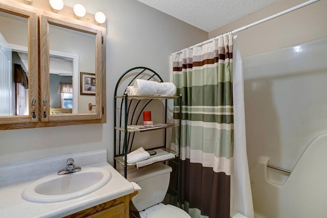 bathroom featuring vanity, curtained shower, toilet, and a textured ceiling