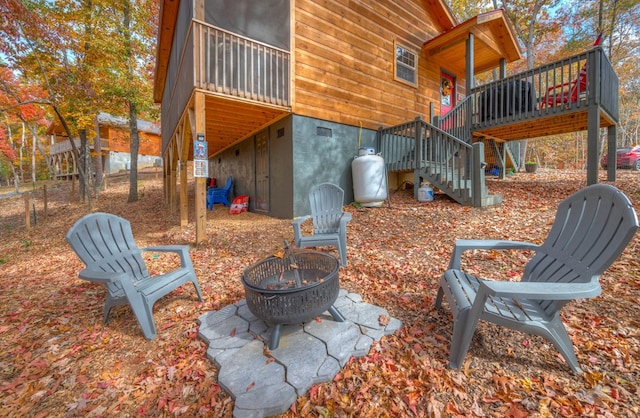 view of patio / terrace with an outdoor fire pit and a wooden deck