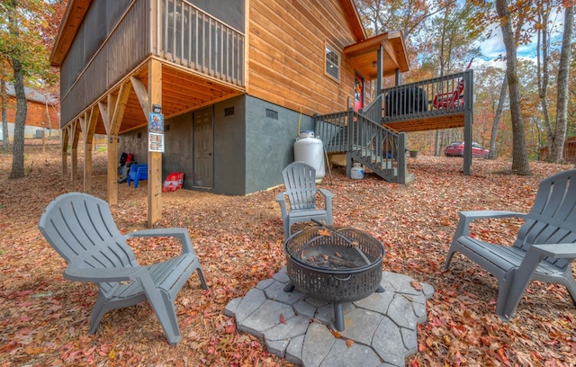 view of patio / terrace with a fire pit and a deck