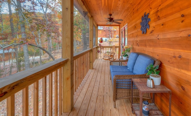 deck featuring covered porch and ceiling fan