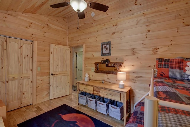 bedroom featuring vaulted ceiling, ceiling fan, wooden ceiling, hardwood / wood-style floors, and wood walls