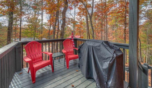 wooden deck with a grill