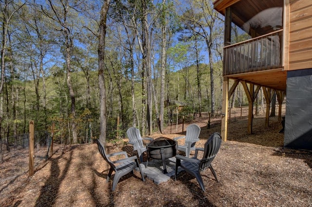 view of yard with a balcony and an outdoor fire pit