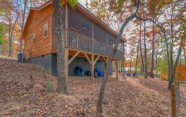 rear view of house featuring a sunroom, ceiling fan, and central AC