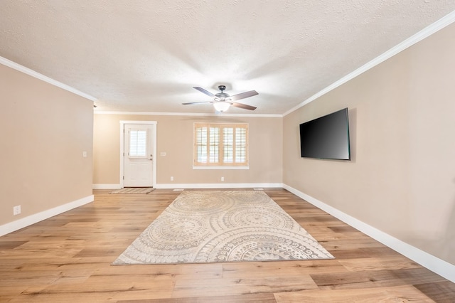 365 Quarles Ln, Ellijay, GA 30540 - unfurnished living room featuring crown molding, ceiling fan, light wood-style flooring, and a textured ceiling