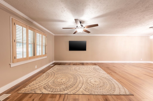 365 Quarles Ln, Ellijay, GA 30540 - empty room featuring wood finished floors, a textured ceiling, a ceiling fan, and crown molding