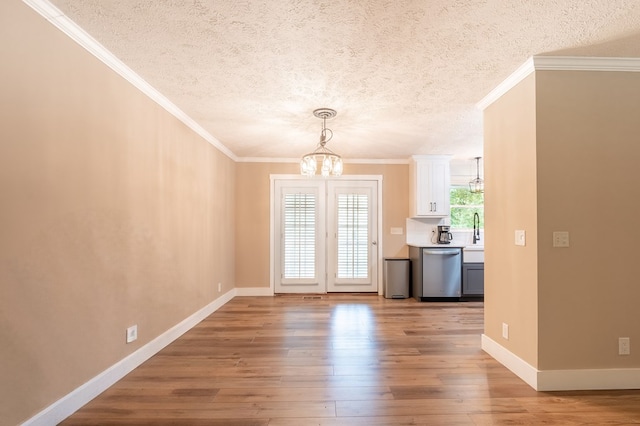 365 Quarles Ln, Ellijay, GA 30540 - unfurnished dining area featuring a chandelier, wood-type flooring, a textured ceiling, and crown molding