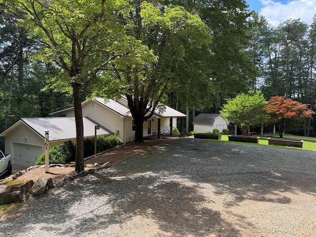 365 Quarles Ln, Ellijay, GA 30540 - view of front of property with driveway, a shed, an attached garage, and view of scattered trees