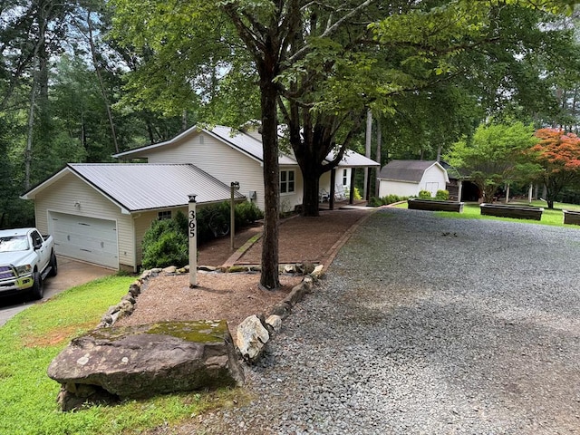 365 Quarles Ln, Ellijay, GA 30540 - single story home with concrete driveway, an attached garage, a metal roof, and view of scattered trees
