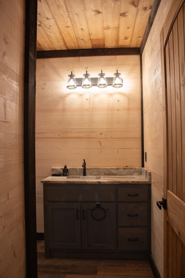 bathroom featuring vanity, wooden ceiling, and wood walls