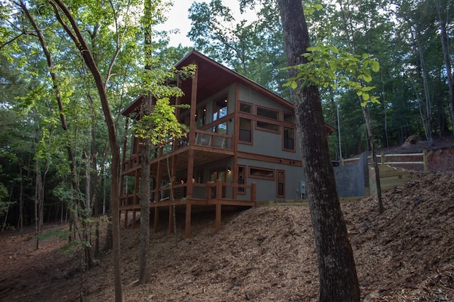 rear view of house featuring a sunroom