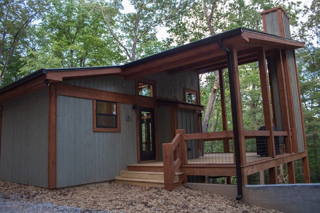 rear view of house featuring a wooden deck