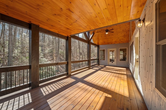 unfurnished sunroom with lofted ceiling, ceiling fan, and wooden ceiling