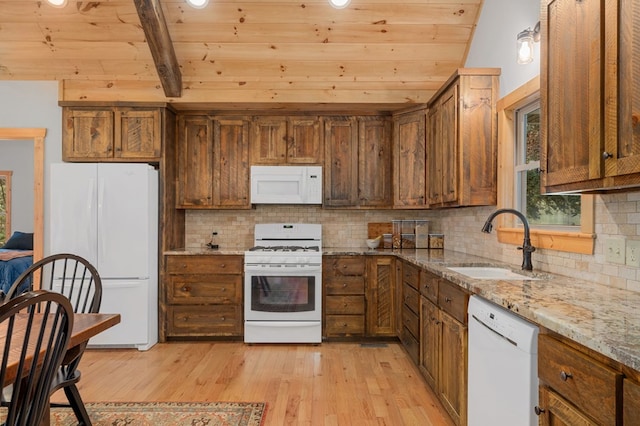 kitchen with light stone counters, light wood-style flooring, white appliances, a sink, and wood ceiling