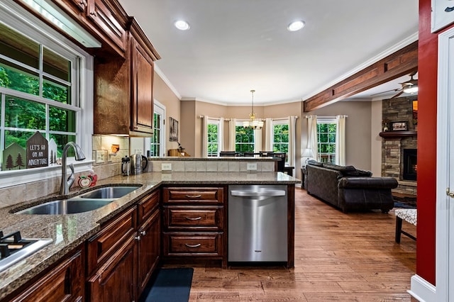 615 Navaho Way, Ellijay, GA 30540 - kitchen featuring stainless steel appliances, a sink, crown molding, wood finished floors, and a stone fireplace