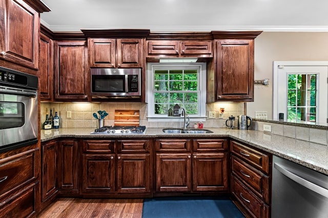 615 Navaho Way, Ellijay, GA 30540 - kitchen with appliances with stainless steel finishes, a sink, ornamental molding, light stone counters, and decorative backsplash