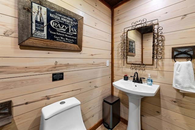 615 Navaho Way, Ellijay, GA 30540 - bathroom featuring wood walls, toilet, and a sink