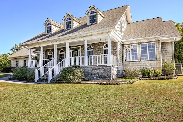 new england style home featuring central AC, a front lawn, and a porch