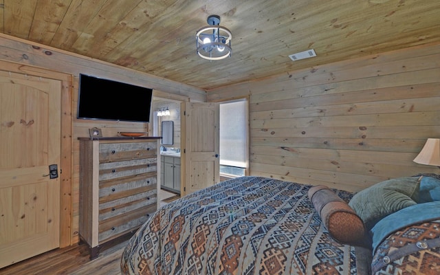 bedroom featuring visible vents, wood walls, wood finished floors, and wood ceiling