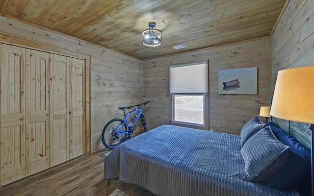 bedroom featuring wood ceiling, wood walls, and wood finished floors