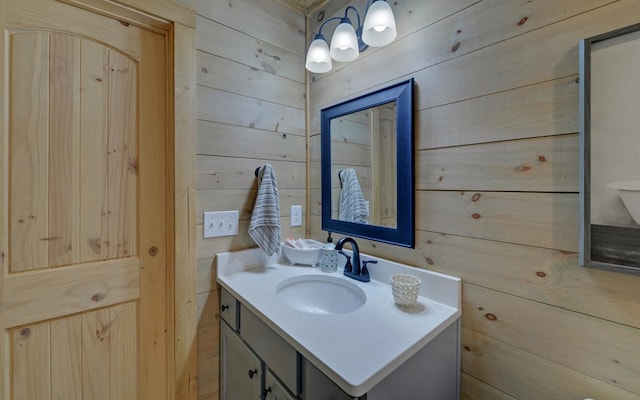 bathroom featuring wooden walls and vanity