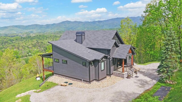 433 Hawkeye Trl, Marble, NC 28905 - view of side of property featuring a chimney, a shingled roof, driveway, a mountain view, and a forest view