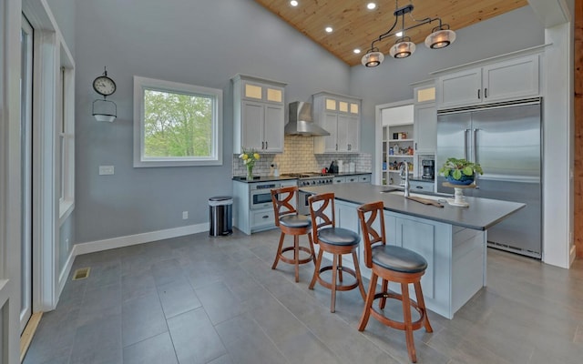 433 Hawkeye Trl, Marble, NC 28905 - kitchen with wooden ceiling, recessed lighting, high quality appliances, wall chimney range hood, and dark countertops