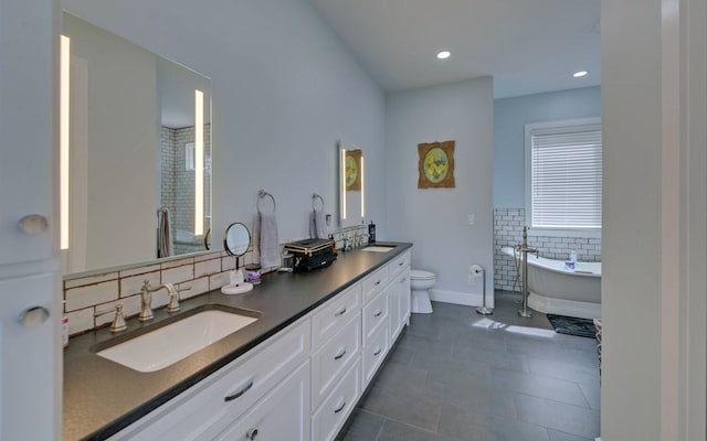 433 Hawkeye Trl, Marble, NC 28905 - bathroom with tile patterned floors, double vanity, tile walls, a sink, and a soaking tub