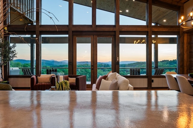 interior space featuring a mountain view, high vaulted ceiling, and wooden ceiling