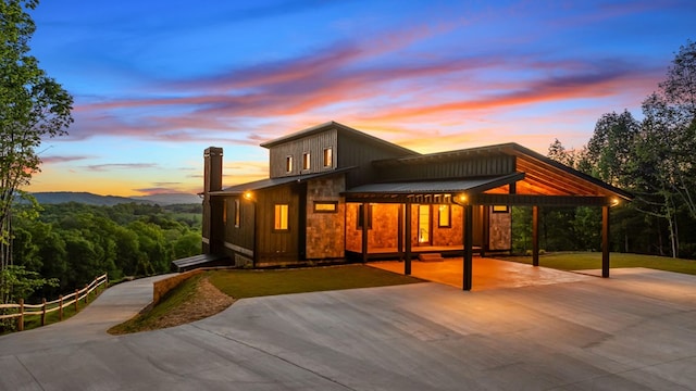 exterior space featuring metal roof and driveway