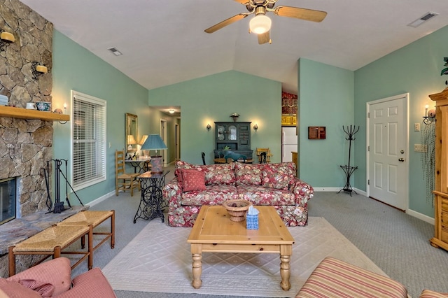 living room with ceiling fan, light colored carpet, lofted ceiling, and a fireplace