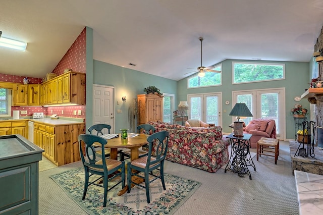 carpeted dining room with french doors, high vaulted ceiling, and ceiling fan