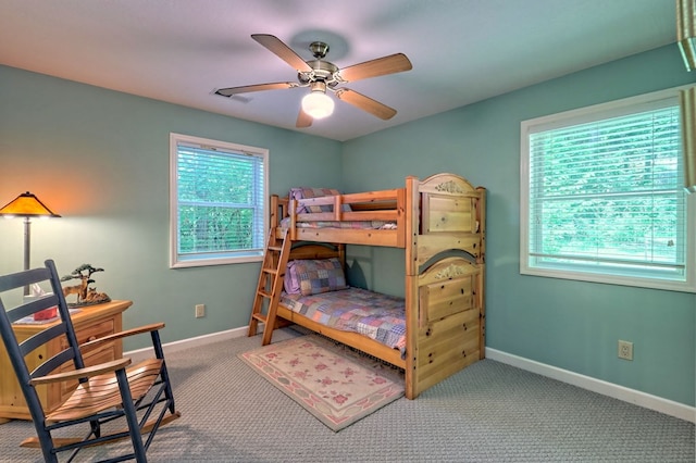 bedroom featuring ceiling fan and carpet