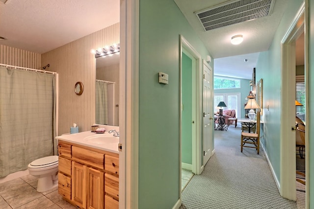 bathroom with tile patterned floors, vanity, toilet, curtained shower, and lofted ceiling