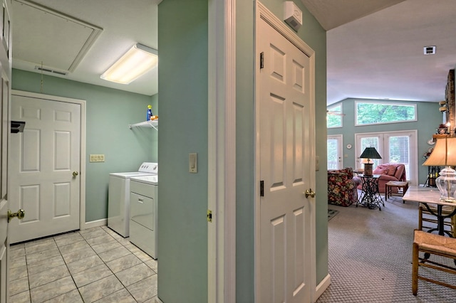 washroom with washer and dryer, light colored carpet, and french doors