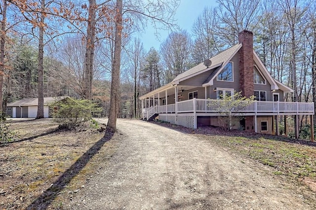 view of home's exterior featuring a garage and a chimney