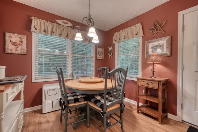 2284 Lovingood Rd, Hiawassee, GA 30546 - dining area featuring baseboards, a chandelier, light wood-style flooring, and a textured ceiling