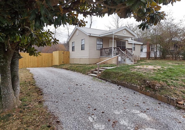 view of front of house with a porch and a front yard